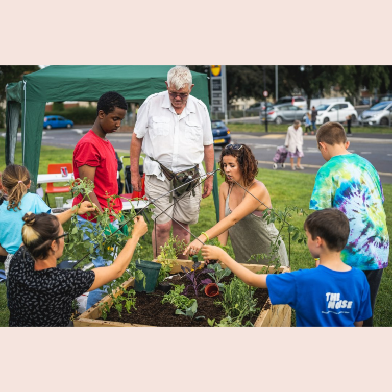 Photo of a group of people gardening outside