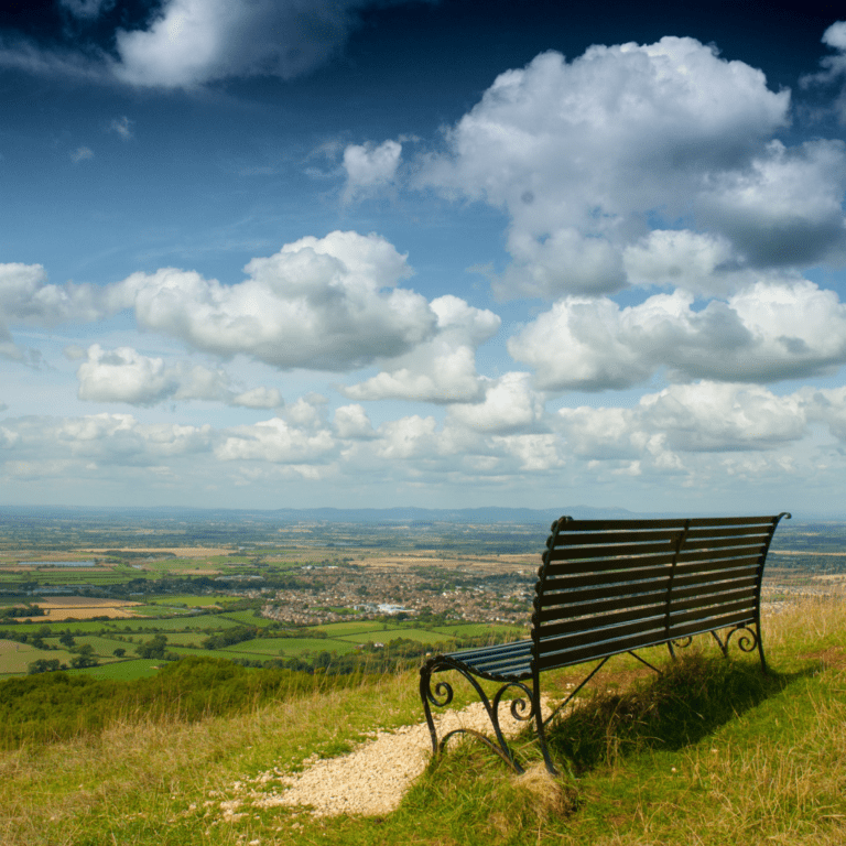 Bench looking over view of fields and city