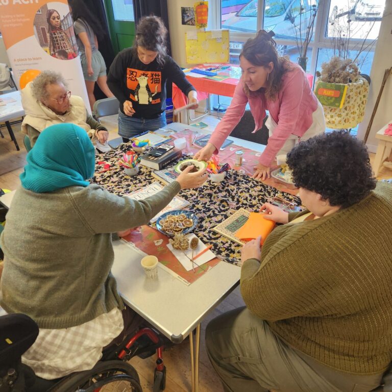 People sitting around a table in a community centre