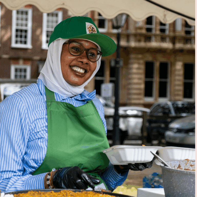 Smiling person serving food
