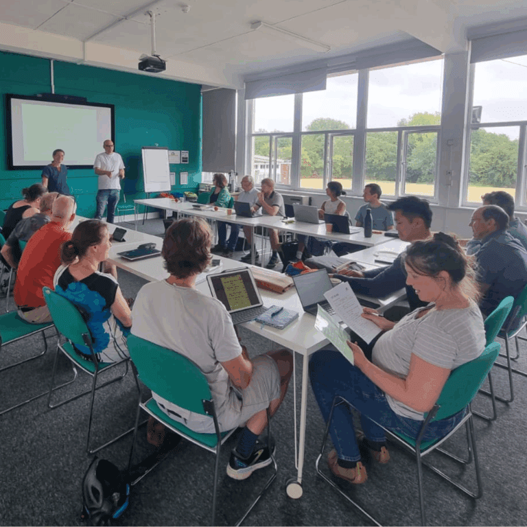 People sat around a table listening to a presentation