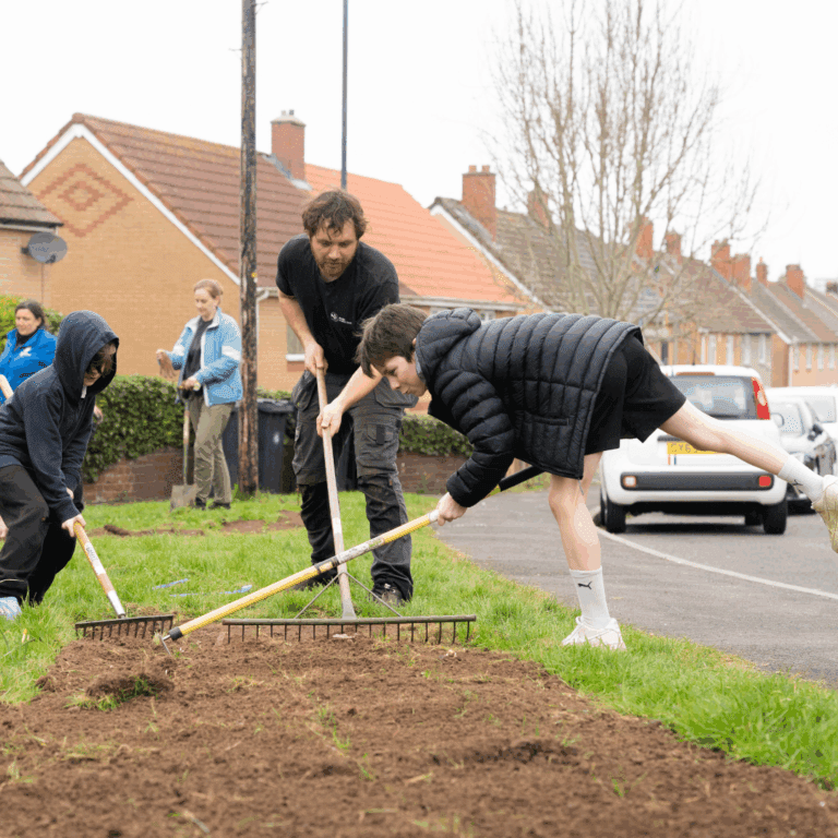 Two children and a man gardening