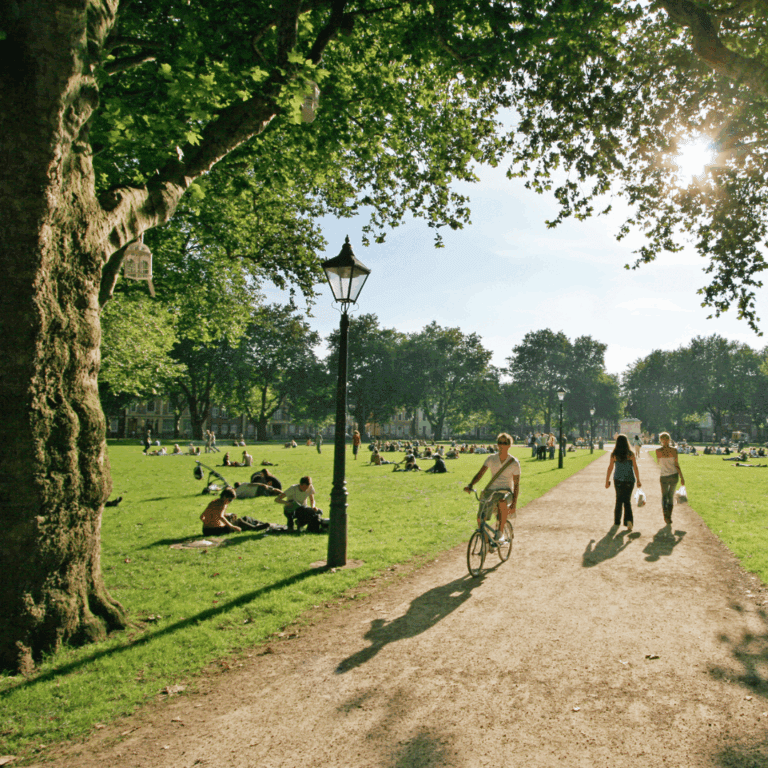 People walking and cycling through Queens Square