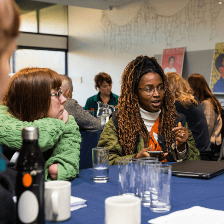 People sat around a table having a conversation.