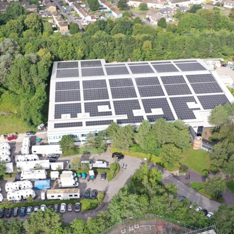 Birds eye view of The Bottle Yard film studio and car park with solar panels on the roof.
